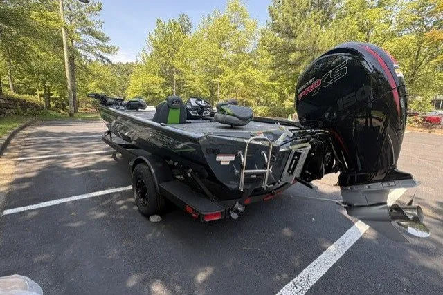 Slide: The Image of 2027 Ranger RT198P boat with powerful engine, parked in a scenic wooded area. - 8