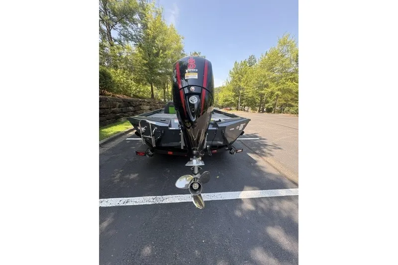 Slide: The Image of 2027 Ranger RT198P boat with outboard motor in a parking lot. - 7