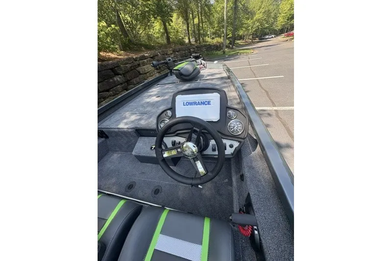 Slide: The Image of 2027 Ranger RT198P boat dashboard with Lowrance display, steering wheel, and green-accented seats. - 4