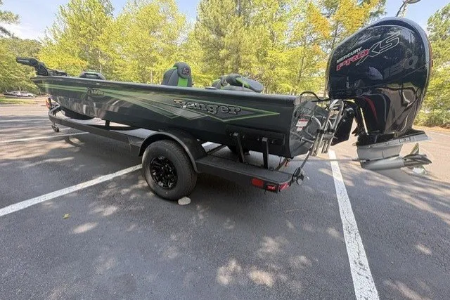Slide: The Image of 2027 Ranger RT198P boat on trailer, parked in a wooded area. - 3