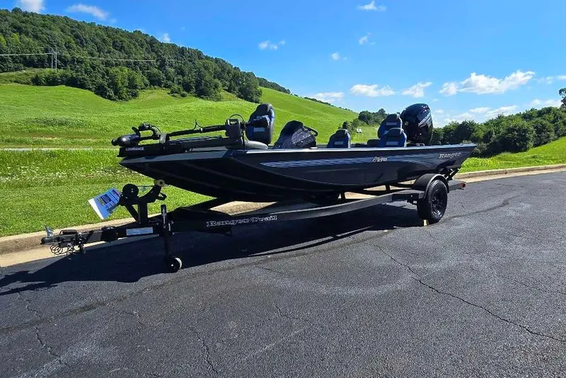Slide: The Image of 2027 Ranger RT178 boat on trailer, parked on road with scenic green hills. - 7