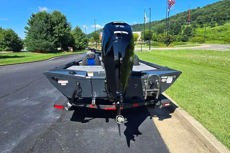 Slide: The Image of 2027 Ranger RT178 boat with outboard motor on a trailer, parked on a sunny day. - 5