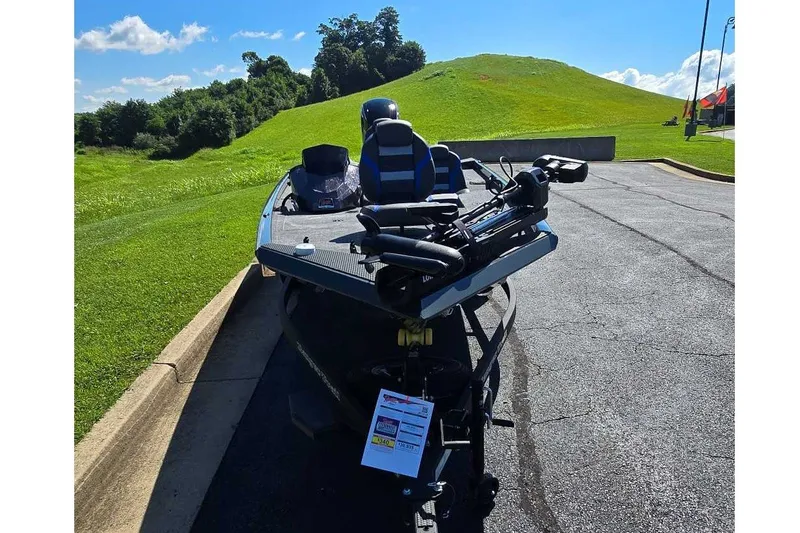 Slide: The Image of 2027 Ranger RT178 boat parked on asphalt near grassy hill under blue sky. - 9