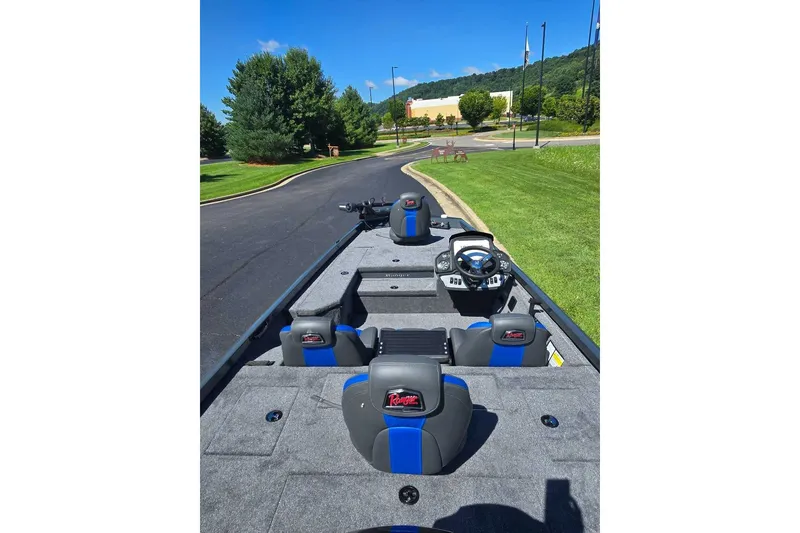 Slide: The Image of 2027 Ranger RT178 boat interior with blue accents, parked on a sunny day. - 6
