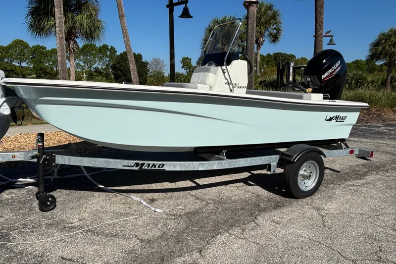 The Image of 2026 Mako Pro Skiff 13 CC boat on trailer, parked outdoors with palm trees. - 0