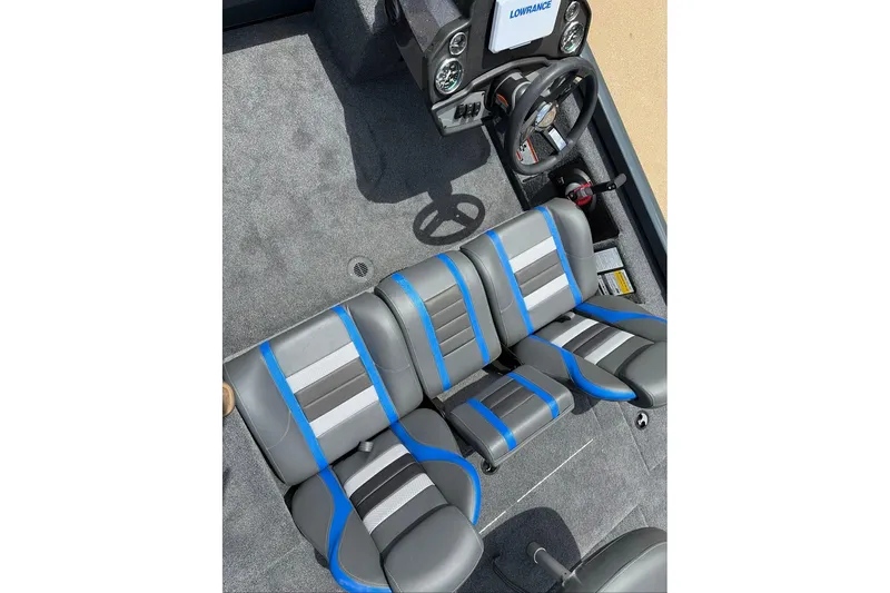 Slide: The Image of 2027 Ranger RT188C boat interior with gray and blue seating, steering wheel, and dashboard. - 10