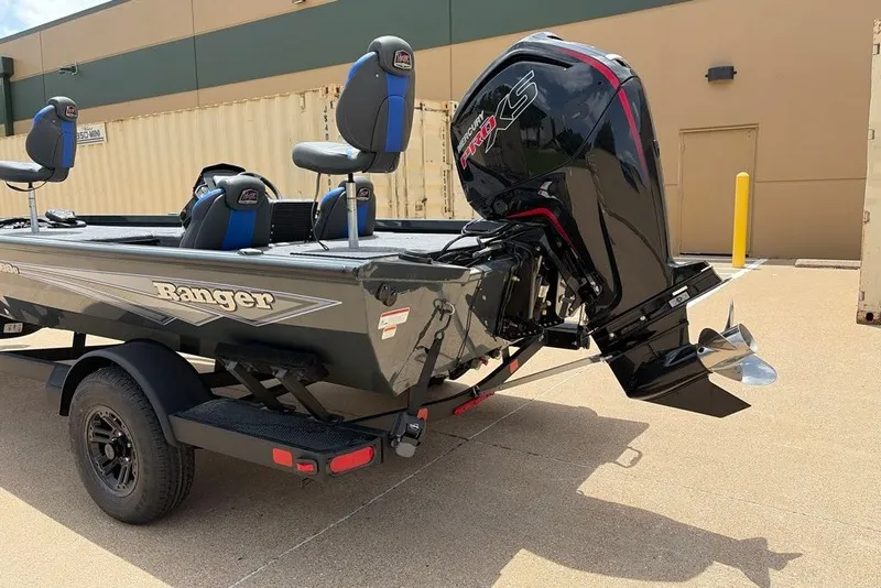 Slide: The Image of 2027 Ranger RT188C boat with powerful outboard motor, parked on a trailer. - 11