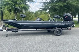 The Image of 2027 Ranger RT188C fishing boat on trailer, parked outdoors. - 0