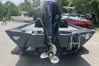 Slide: The Image of 2027 Ranger RT188C boat, rear view, parked outdoors with motor and propeller visible. - 4