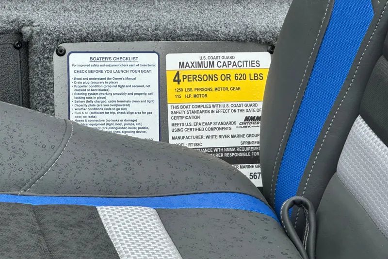 Slide: The Image of 2027 Ranger RT188C boat seat with U.S. Coast Guard capacity label, raindrops visible. - 16