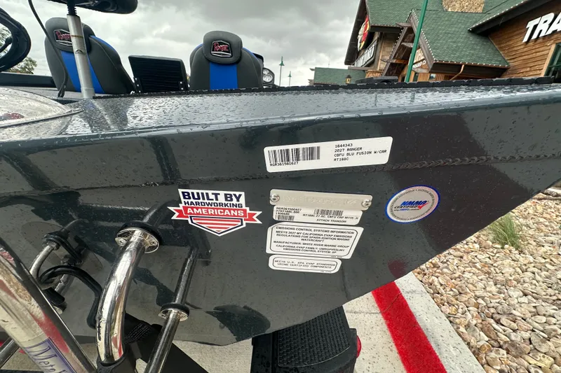 Slide: The Image of 2027 Ranger RT188C boat with "Built by Hardworking Americans" sticker, wet from rain. - 12