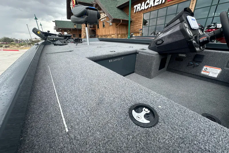 Slide: The Image of 2027 Ranger RT188C fishing boat interior with carpeted deck and control panel. - 17