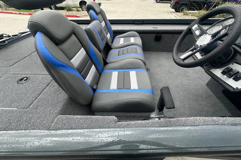 Slide: The Image of Interior of 2027 Ranger RT188C boat with gray and blue seating, steering wheel visible. - 20
