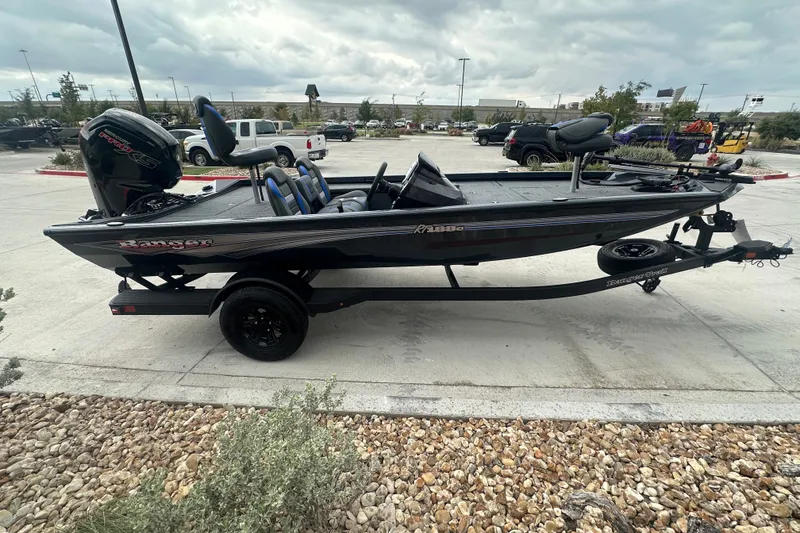 The Image of 2027 Ranger RT188C fishing boat on trailer in parking lot, side view. - 0