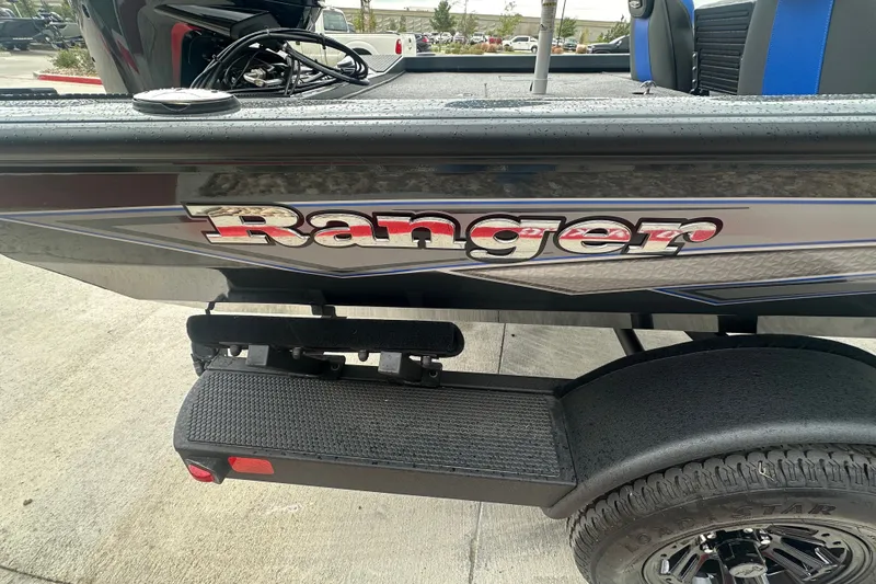 Slide: The Image of 2027 Ranger RT188C boat with logo, black exterior, and trailer tire visible. - 10