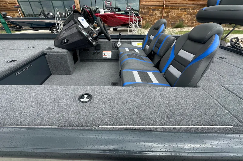 Slide: The Image of 2027 Ranger RT188C boat interior with gray and blue seating, modern dashboard, and spacious layout. - 15