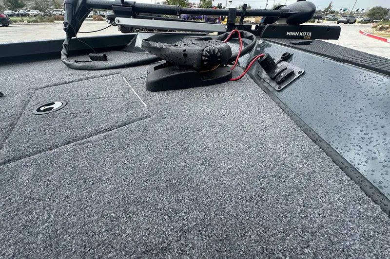 Slide: The Image of 2027 Ranger RT188C boat deck with Minn Kota trolling motor, wet from rain. - 18