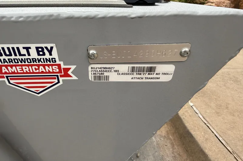 Slide: The Image of 2027 Tracker Bass Tracker Classic CC boat with identification labels and patriotic sticker. - 13