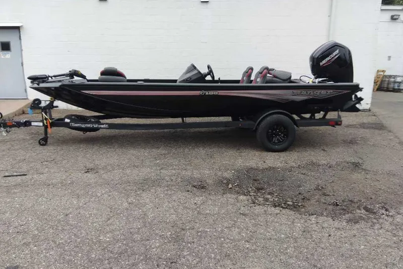 Slide: The Image of 2027 Ranger RT188 boat on trailer, black with red accents, parked outdoors. - 68
