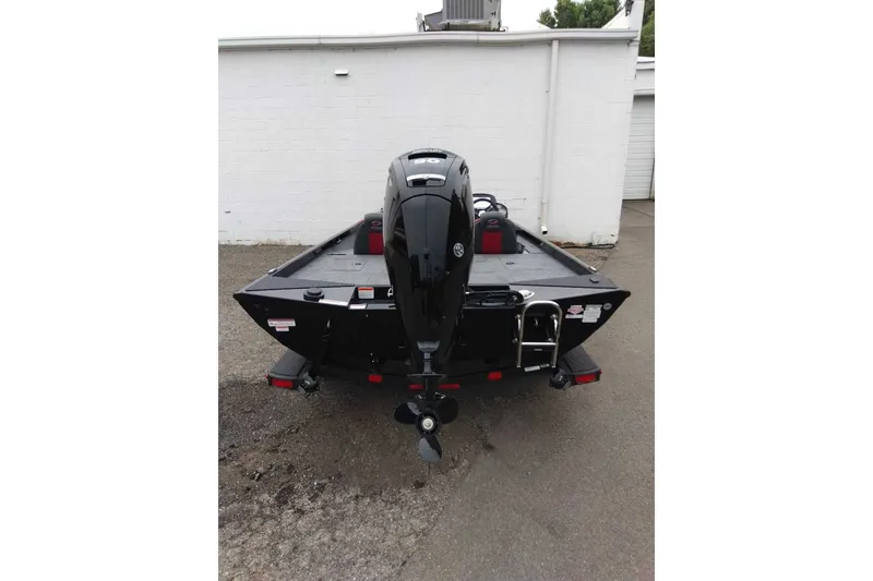Slide: The Image of 2027 Ranger RT188 boat, rear view, black exterior, parked on pavement. - 5