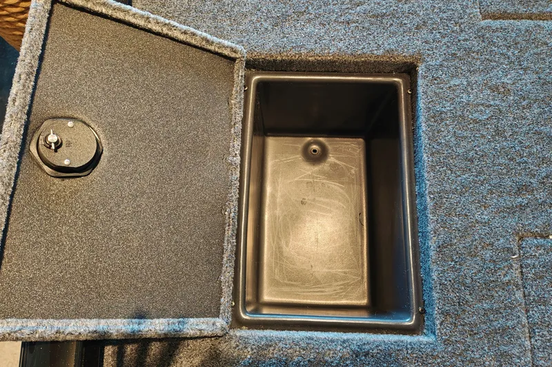 Slide: The Image of Open storage compartment in 2027 Ranger RT178 boat with carpeted interior. - 45