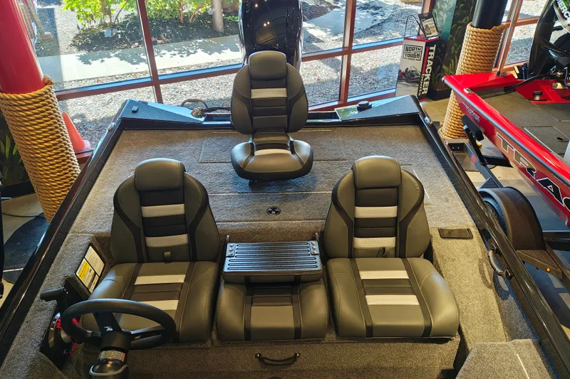 Slide: The Image of 2027 Ranger RT178 boat interior with three black and gray seats, showroom display. - 39
