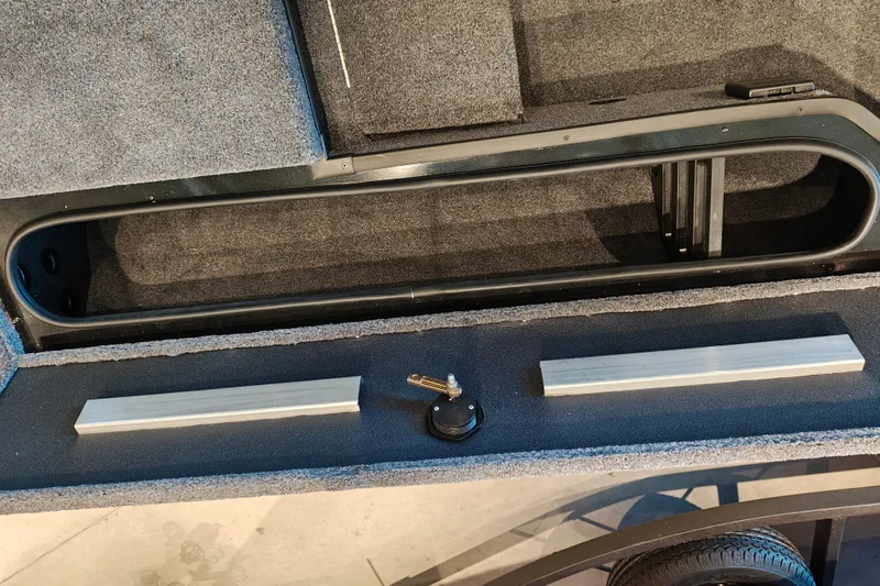 Slide: The Image of 2027 Ranger RT178 boat storage compartment with key and accessories. - 31