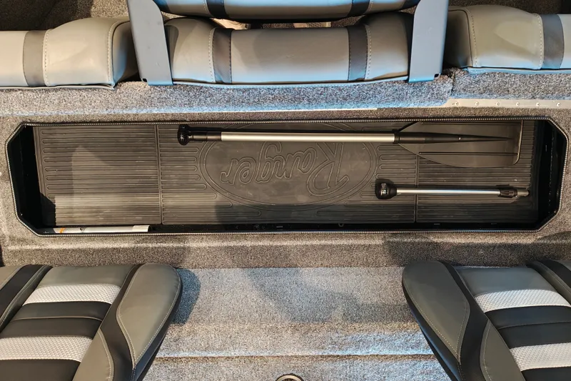 Slide: The Image of 2027 Ranger RT178 boat storage compartment with paddles and seating. - 40