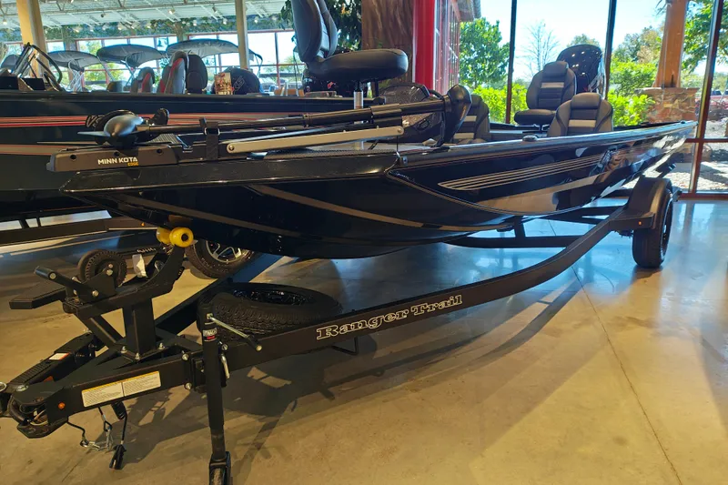 Slide: The Image of 2027 Ranger RT178 boat on display in showroom, featuring Minn Kota trolling motor. - 2