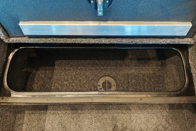 Slide: The Image of Storage compartment of 2027 Ranger RT178 boat, featuring carpeted interior and drainage vent. - 28