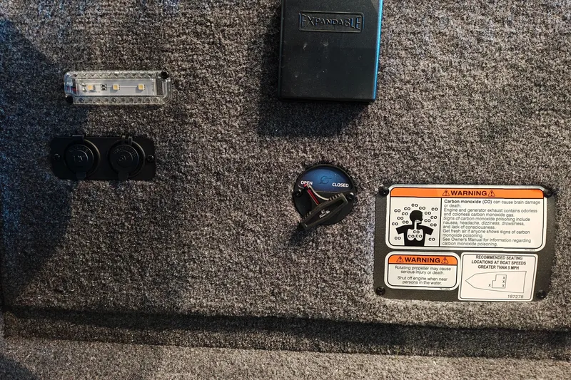 Slide: The Image of Control panel of a 2027 Ranger RT178 boat with warning labels and switches. - 22