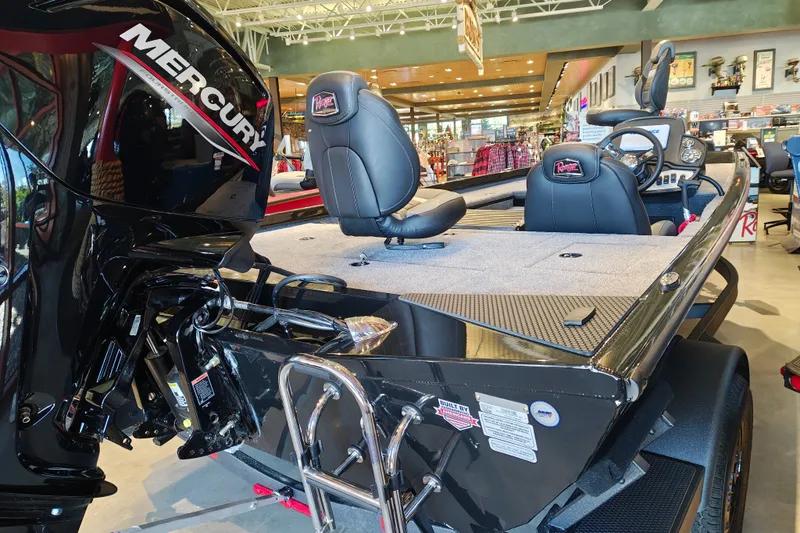 Slide: The Image of 2027 Ranger RT178 boat with Mercury engine, displayed indoors, featuring comfortable seating and modern design. - 11