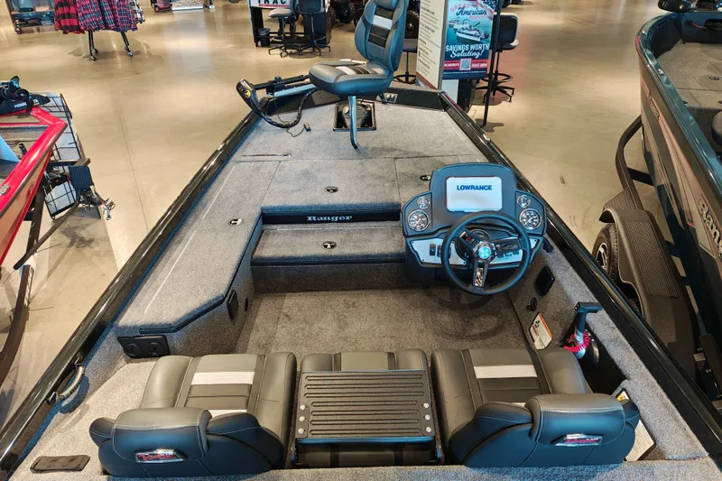 Slide: The Image of 2027 Ranger RT178 boat interior with steering console and seating, displayed in showroom. - 12
