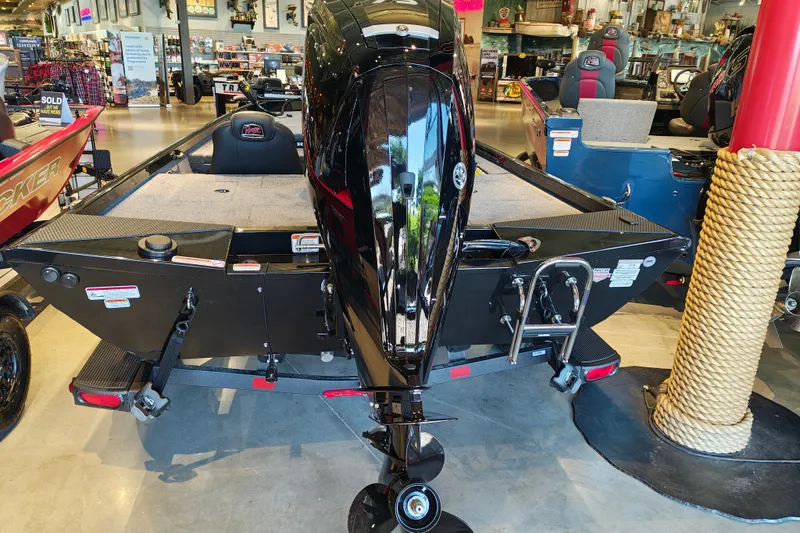 Slide: The Image of 2027 Ranger RT178 boat displayed in showroom, rear view with motor and ladder. - 9