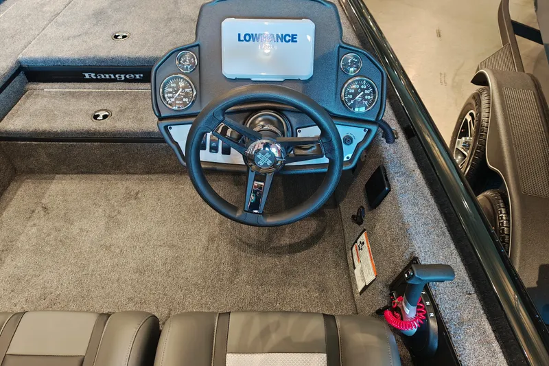 Slide: The Image of 2027 Ranger RT178 boat dashboard with steering wheel and Lowrance display. - 17