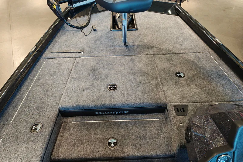 Slide: The Image of 2027 Ranger RT178 boat interior with gray carpet and storage compartments. - 26