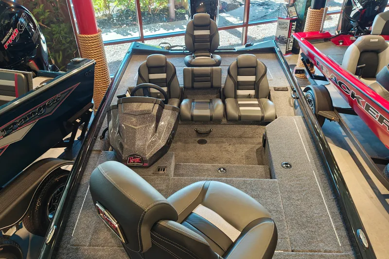 Slide: The Image of 2027 Ranger RT178 boat interior with seating and steering console in showroom. - 38