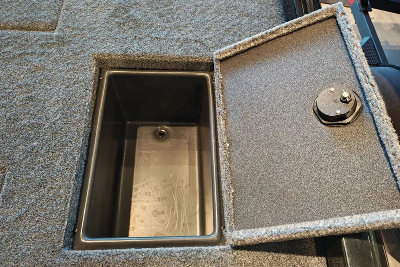 Slide: The Image of Open storage compartment in 2027 Ranger RT178 boat, featuring carpeted lid and secure latch. - 46