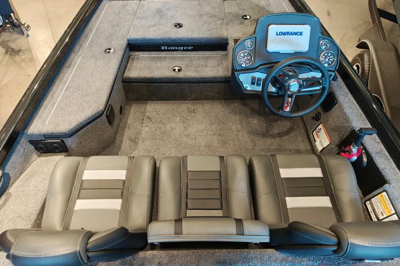Slide: The Image of 2027 Ranger RT178 boat interior with steering wheel and seating, featuring Lowrance electronics. - 16