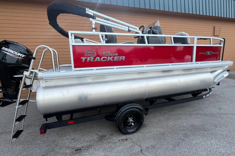 The Image of 2027 Sun Tracker Bass Buggy 16 XL Select pontoon boat with Mercury engine on trailer. - 0