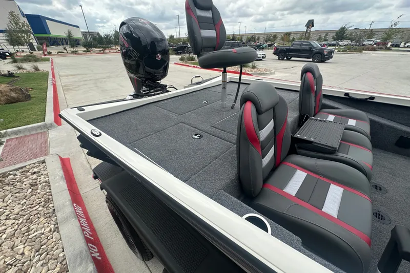 Slide: The Image of 2027 Ranger RT198P boat interior with sleek seating and powerful outboard motor. - 25