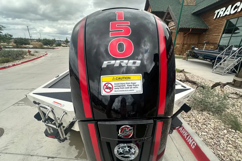 Slide: The Image of 2027 Ranger RT198P boat engine with "150 Pro" label, parked outside a store. - 13