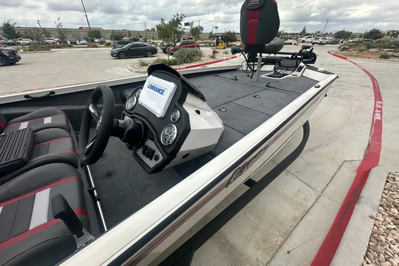 Slide: The Image of 2027 Ranger RT198P boat with modern dashboard and seating in a parking lot. - 24