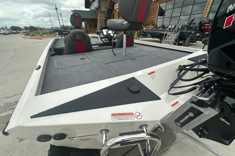 Slide: The Image of 2027 Ranger RT198P boat with gray deck and red-accented seats, displayed outdoors. - 9