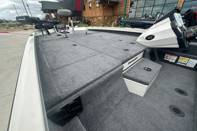 Slide: The Image of 2027 Ranger RT198P boat interior with carpeted deck and fishing seat. - 17