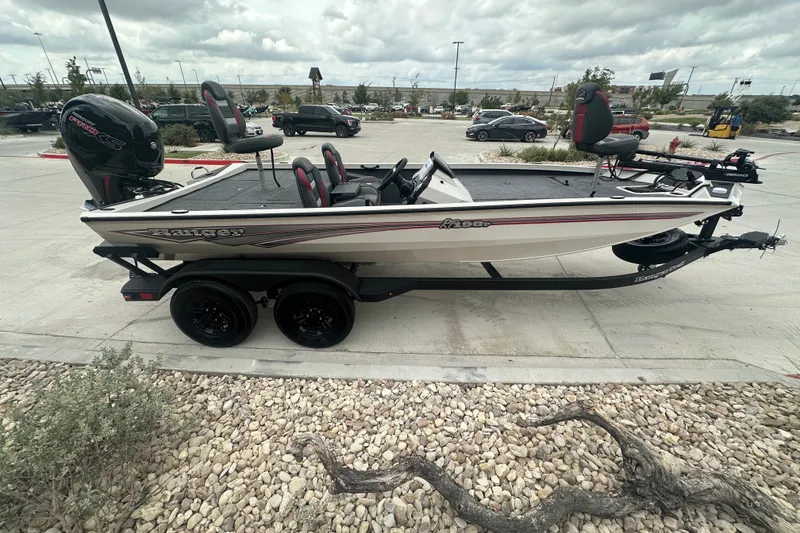 Slide: The Image of 2027 Ranger RT198P fishing boat on trailer, parked outdoors, showcasing sleek design and seating. - 6