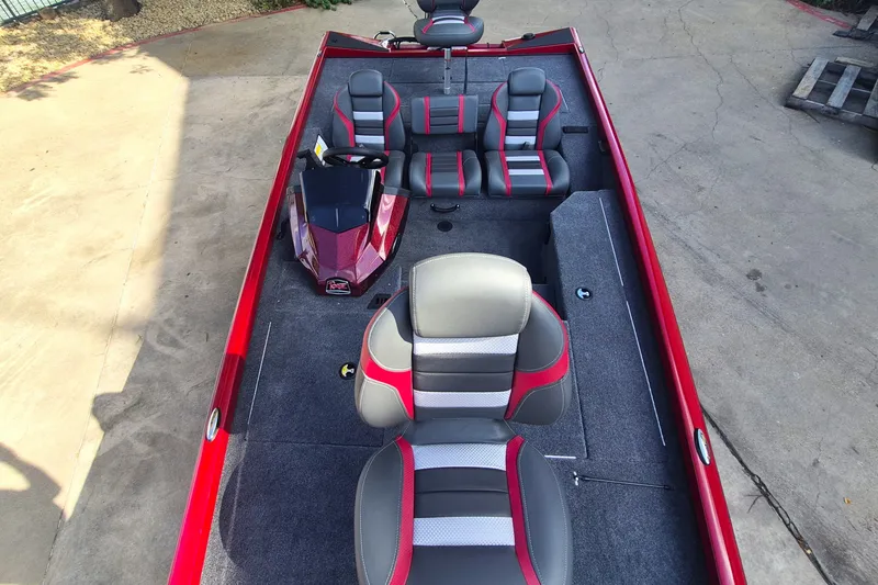 Slide: The Image of 2027 Ranger RT178 boat interior with red and gray seating, steering console, and carpeted floor. - 14