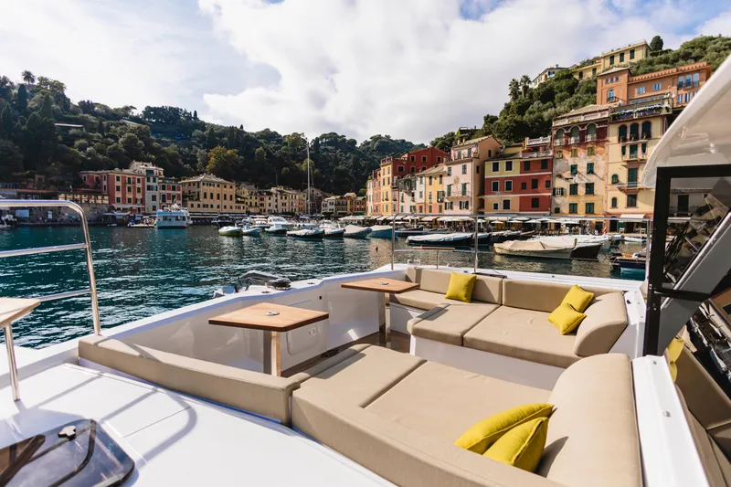 Slide: The Image of Luxurious Aventura 56 Motor Yacht 2026 docked in scenic harbor with colorful buildings. - 32