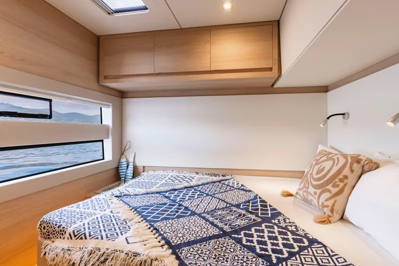 Slide: The Image of Luxurious cabin interior of 2026 Aventura 56 Motor Yacht with elegant bedding and scenic window view. - 16