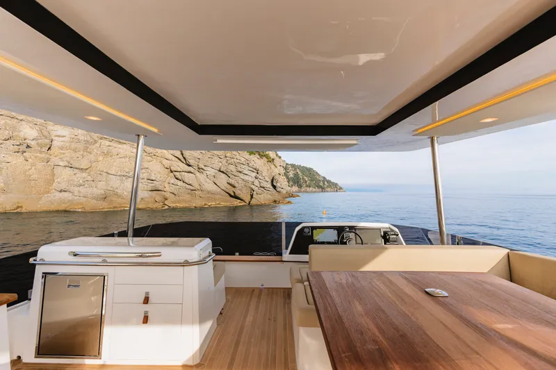 Slide: The Image of Luxurious 2026 Aventura 56 Motor Yacht interior with ocean view and elegant wooden table. - 27